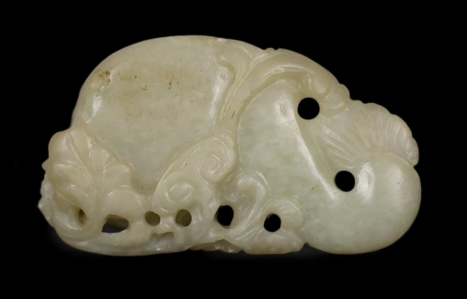 A Chinese pale celadon jade carving of a stylised catfish, probably 17th century